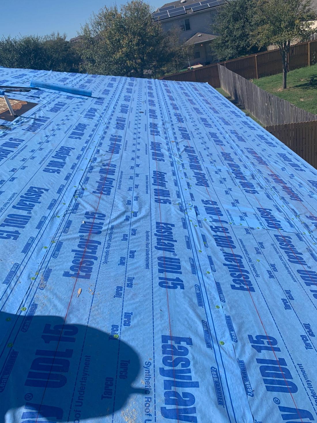 Blue Tarco synthetic underlayment installed on a residential roof deck